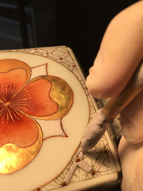 Brush application of water-based gucai over-glaze media on Vase with Flower Medallions; 6 firings.